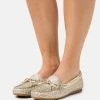 MICHAEL Michael Kors SUTTON - Slip-ons - Pale Gold -MICHAEL Michael Kors shop 9274d4499ccd451aa56d3cd1f002dc5f